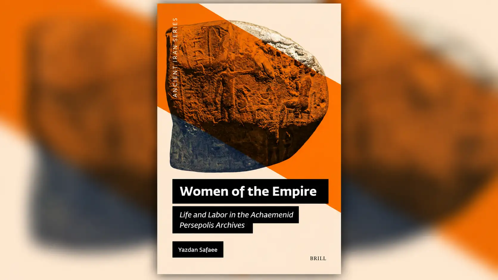 A wide 16:9 composition featuring the book cover of "Women of the Empire: Life and Labor in the Achaemenid Persepolis Archives" by Yazdan Safaee, published by Brill. The vertically oriented cover is sharply displayed in the center, featuring an ancient carved stone relief overlaid with bold diagonal orange shapes against a warm cream background. White typography appears inside contrasting black rectangular blocks. The surrounding left and right areas display an enlarged, heavily Gaussian-blurred version of the same artwork, blending warm orange, earthy brown, cream, and dark blue-gray tones. A subtle drop shadow gives the central cover a slightly elevated appearance, creating an elegant blurred pillarboxing effect.